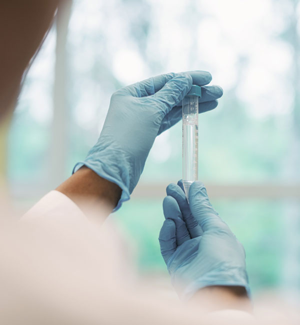 female virologist examining test tube